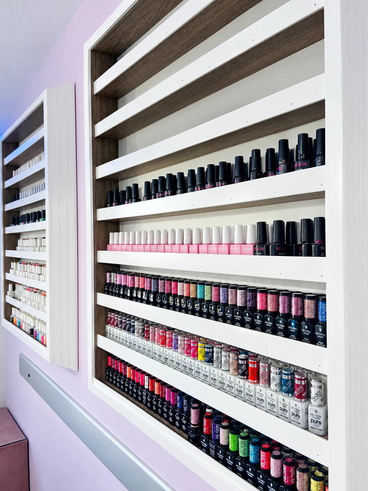 The colour wall at Corallo, rows of gel polish bottles